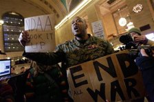 Iraq War veteran Sgt. Shamar Thomas leads a demonstration in New York’s Grand Central Station to call attention to a law signed by President Barack Obama that granted extraordinary powers to the military. 